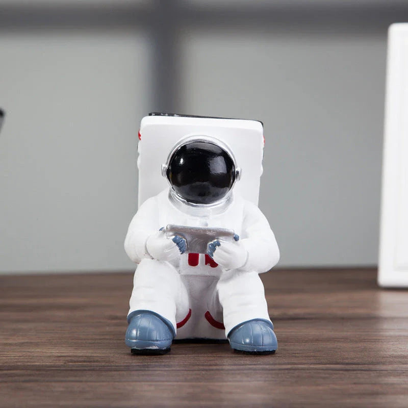 Astronaut-themed resin phone stand with unique design for desk decoration