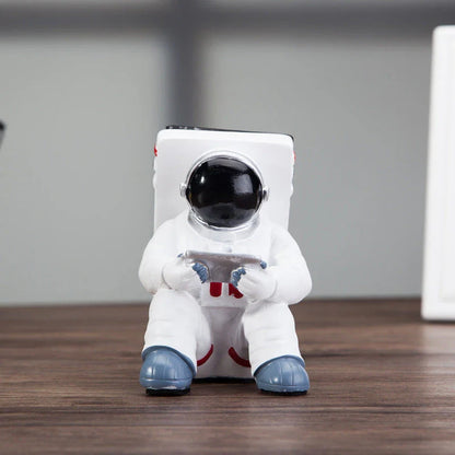 Astronaut-themed resin phone stand with unique design for desk decoration