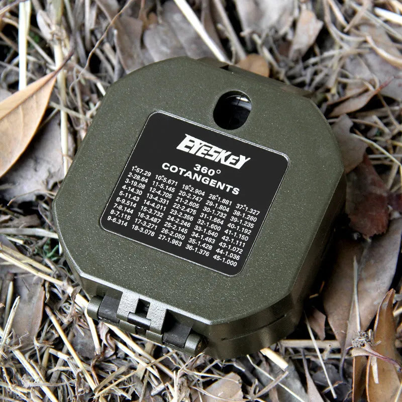 M2 outdoor professional geological compass in green with dimensions 140x83x116mm on a rocky surface