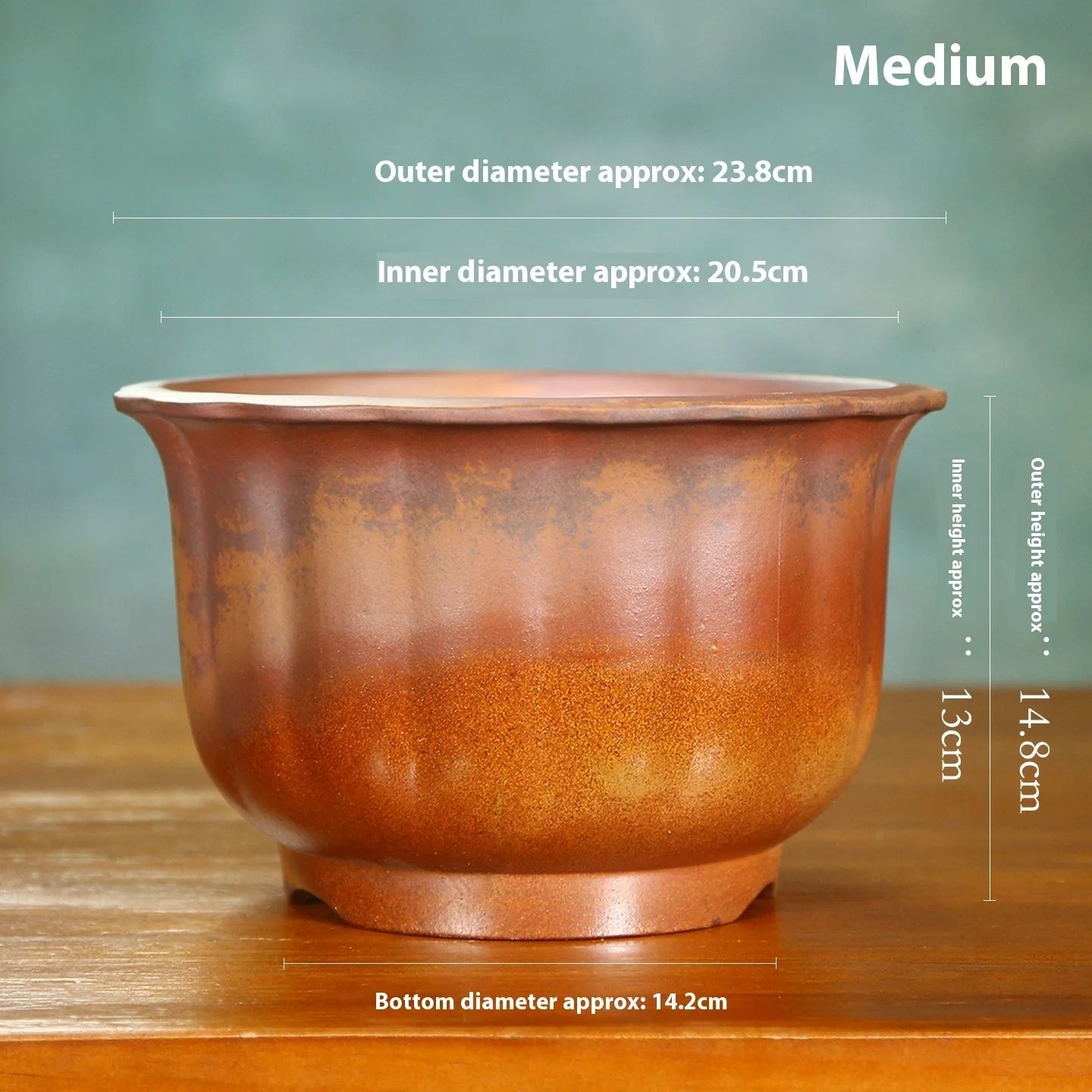 Indoor antique carved purple sand ceramic flowerpot in S1696 firewood colour on a wooden surface.