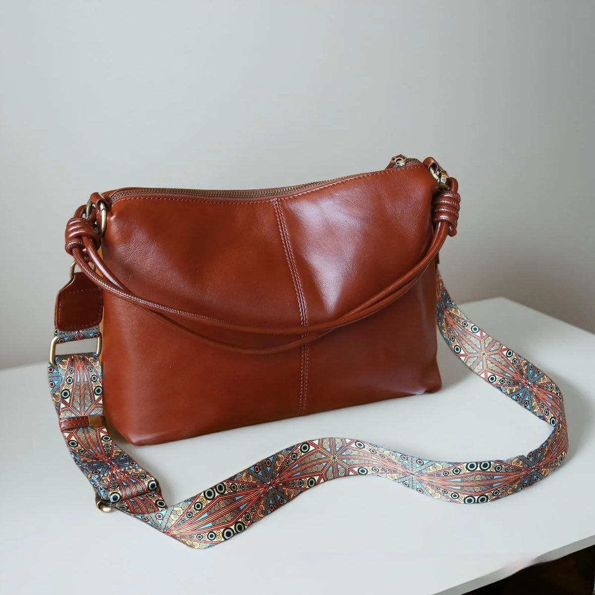 Genuine leather creative large capacity hand shoulder commuter bag in black, pillow shape, 31x11x24cm