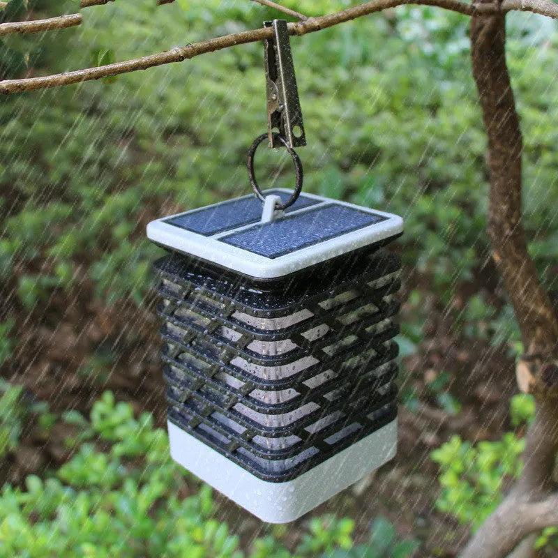 Solar candle flame lawn lamp with 75 yellow LEDs, IP55 rating, placed in a garden setting