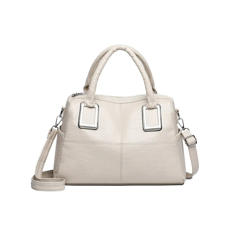 Simple large capacity women's shoulder bag in a neutral colour with internal phone and document pockets.
