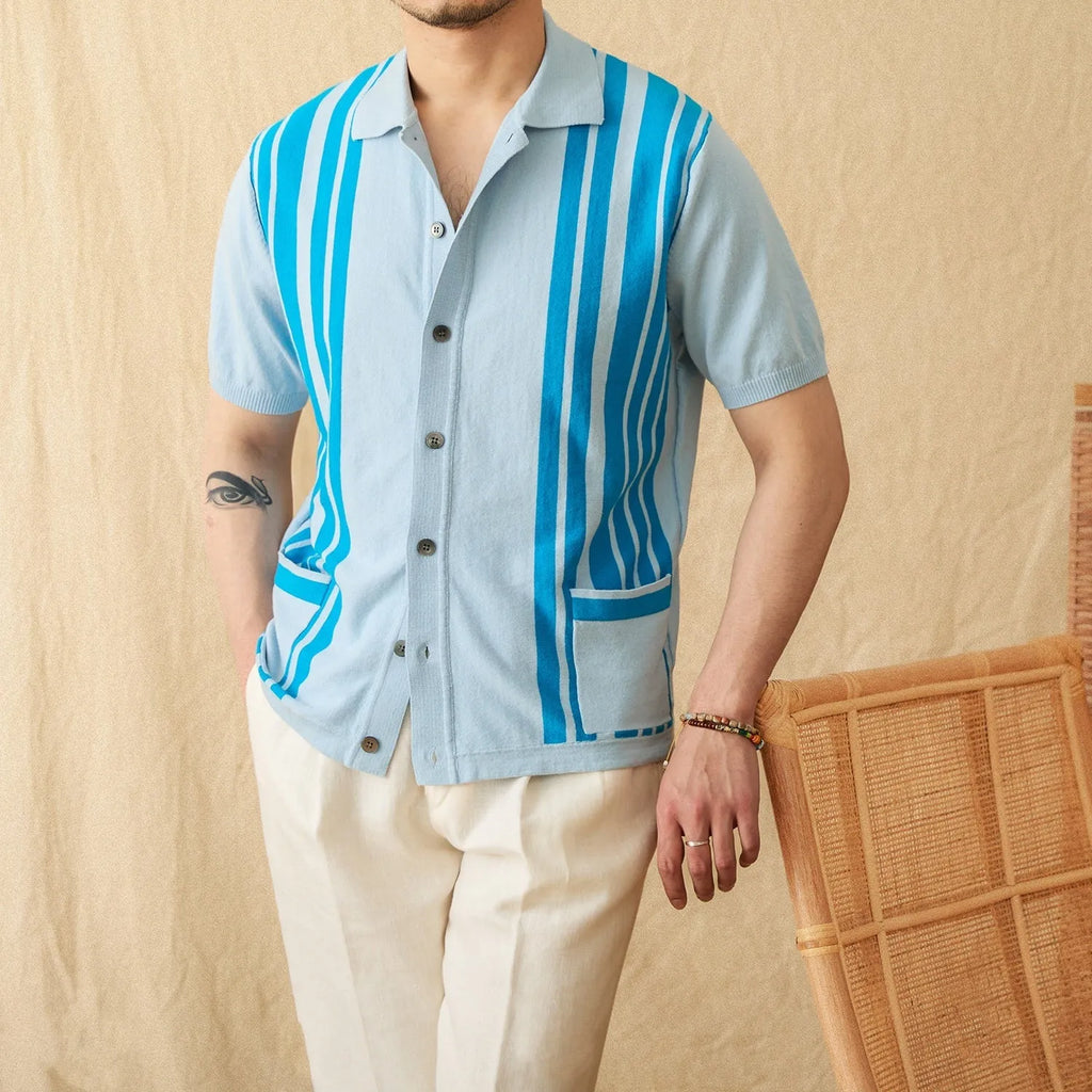 A striped royal blue short-sleeved polo cardigan shirt with a lapel collar, laid flat.