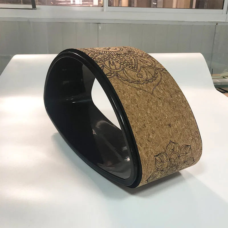 Half-round cork yoga wheel in black and wood grain for backbend and abdominal exercises
