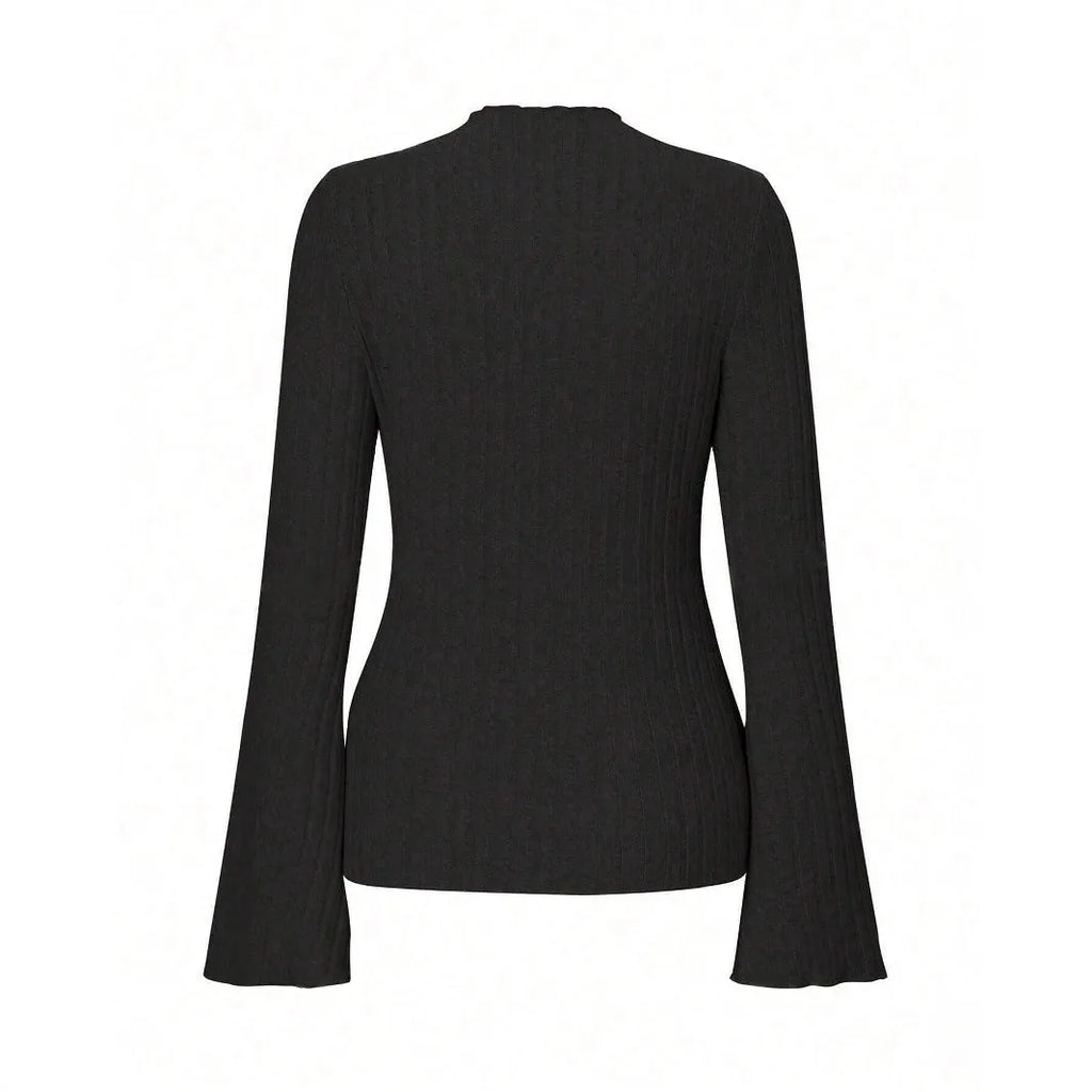 Man wearing a black slim-fit long sleeve top with lantern sleeves and a subtle stripe pattern.
