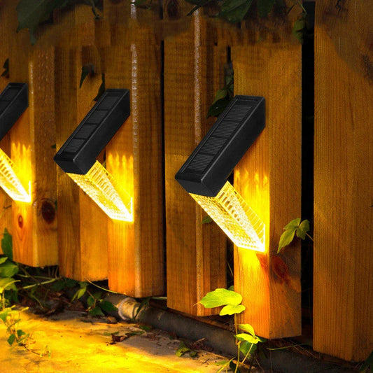 Solar-powered stair lights illuminating a wooden deck in a backyard garden setting