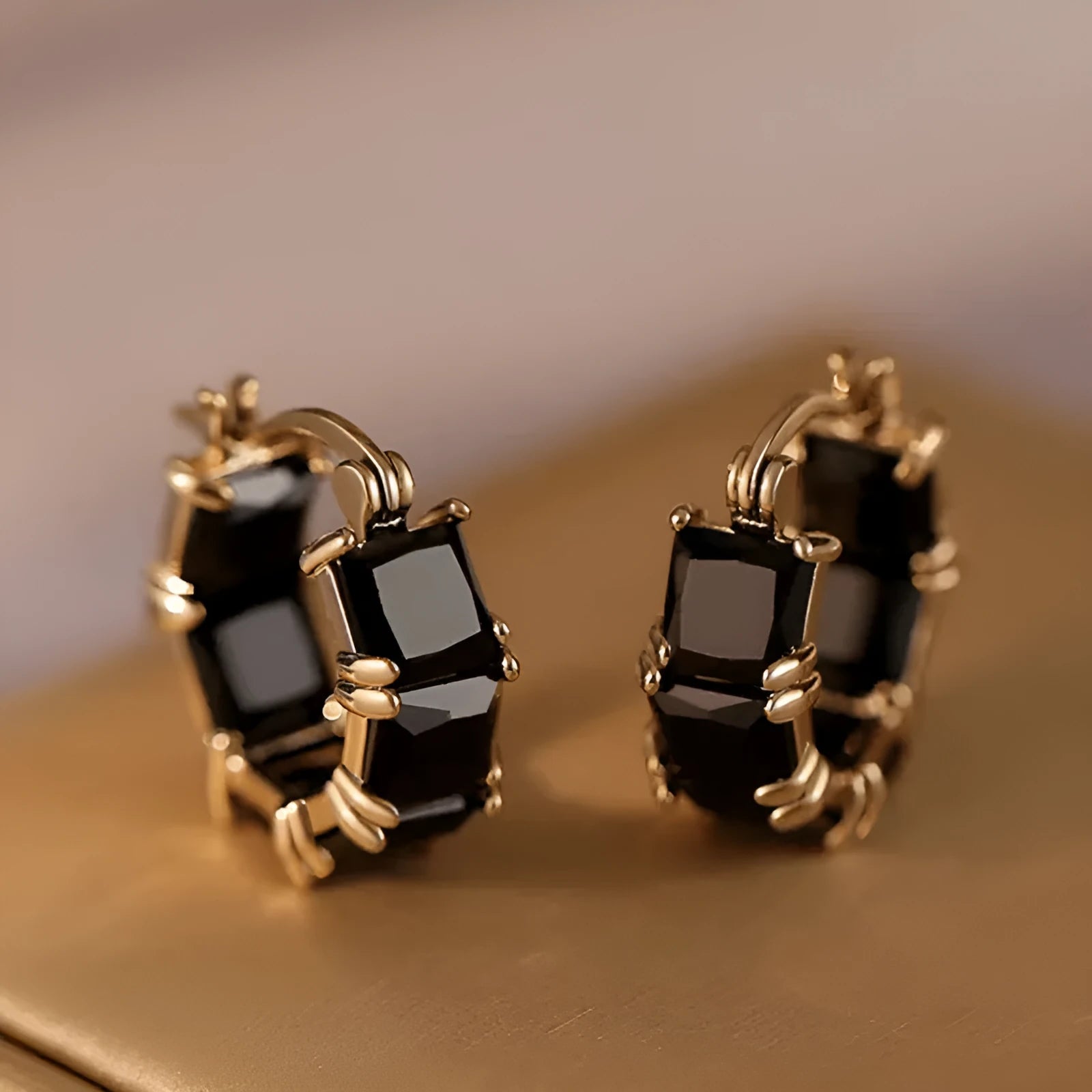Geometric U-shaped gold electroplated earrings with round black zirconium stones