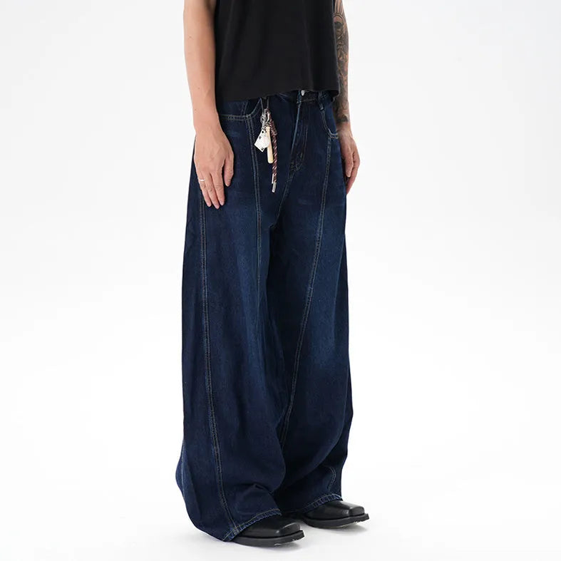 Dark blue washed distressed wide leg machete jeans showing fading and whiskering details