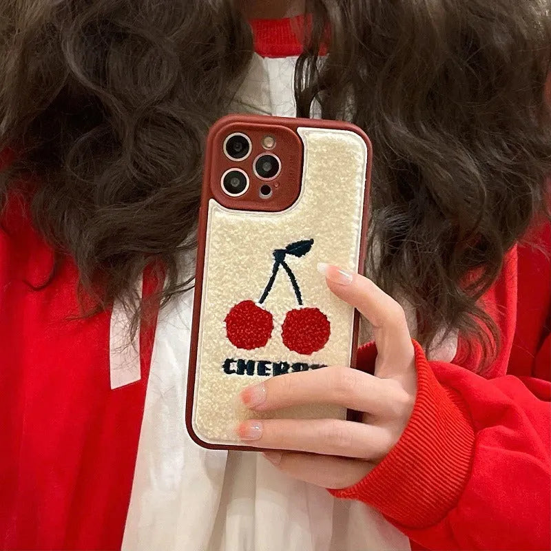 Red plush full lens phone case with cherry design for iPhone showing camera module coverage