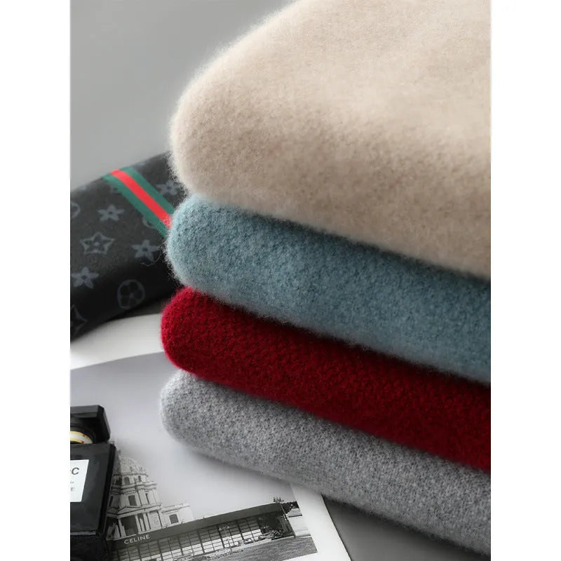 Plus-size model wearing a slim-fit, grey, half-zip wool sweater with a round neckline.
