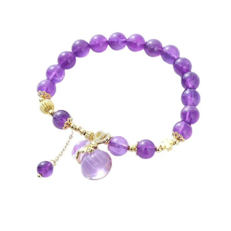 Purple amethyst bracelet with ethnic money bag pendant and peace buckle closure on wrist