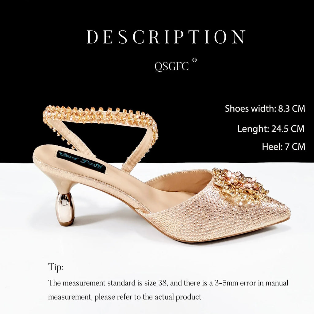 Women's black high heel and clutch bag set with rhinestone ankle chain and floral metal decoration.
