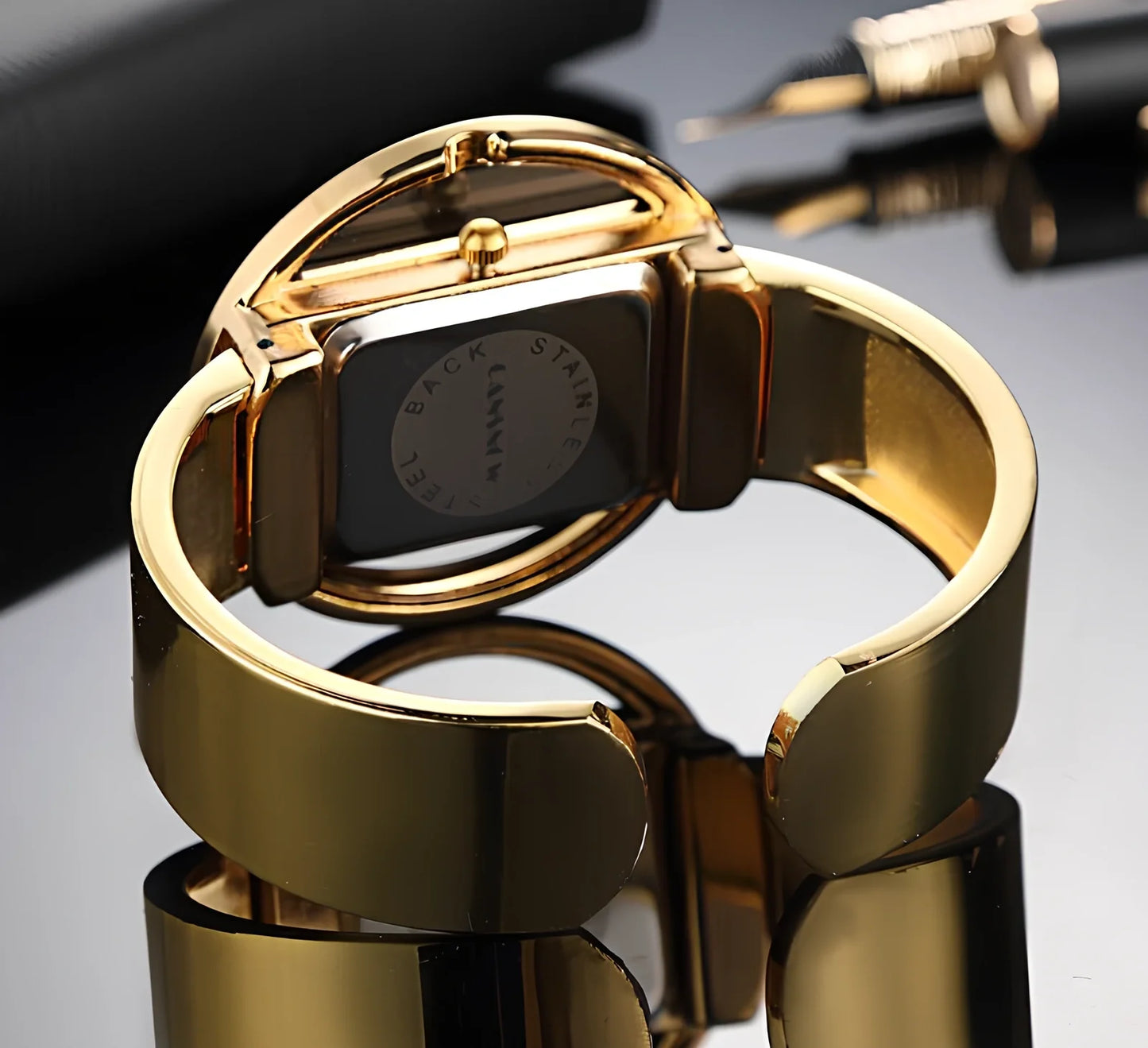 Women's gold black quartz cuff watch with 40mm dial, adjustable steel band 18mm wide, precise movement and water resistant