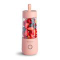 White portable USB rechargeable blender bottle with silicone handle and stainless steel blade.