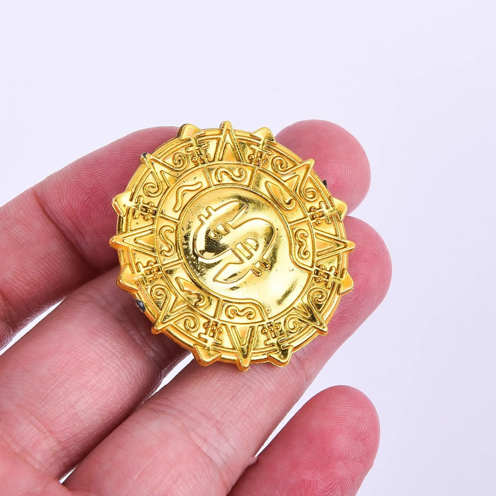 Plastic pirate gold coin toy with pointed tip measuring 3.6cm diameter