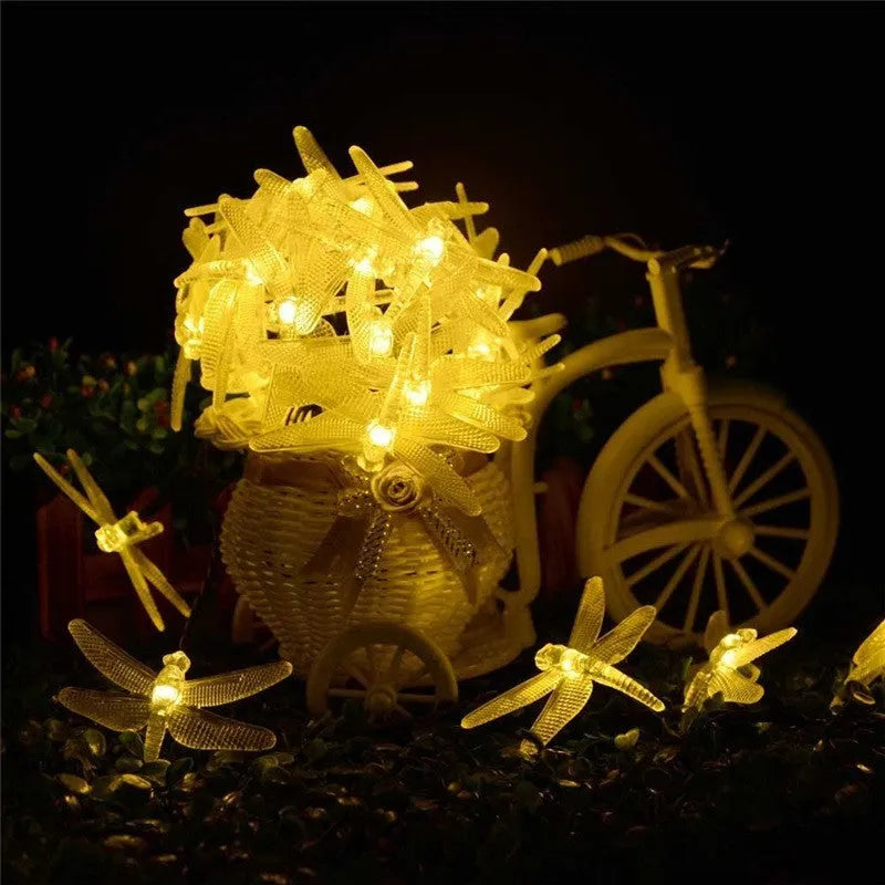 Outdoor solar-powered dragonfly LED string lights with garden spike-mounted panel