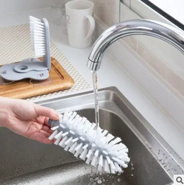 Grey double-headed cup cleaning brush with wall-mounted suction cups for kitchen use