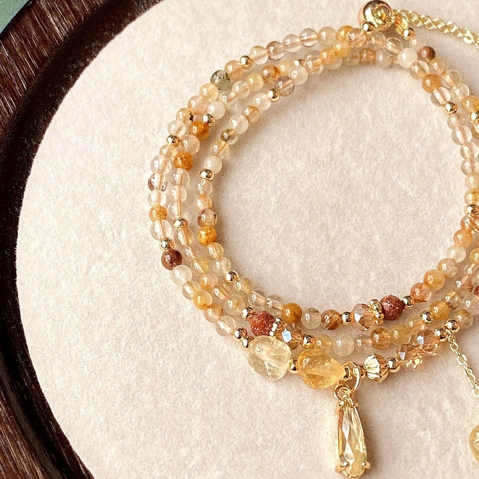Women's natural citrine bracelet with three interconnected circles in caramel gold colour featuring Saturn design elements