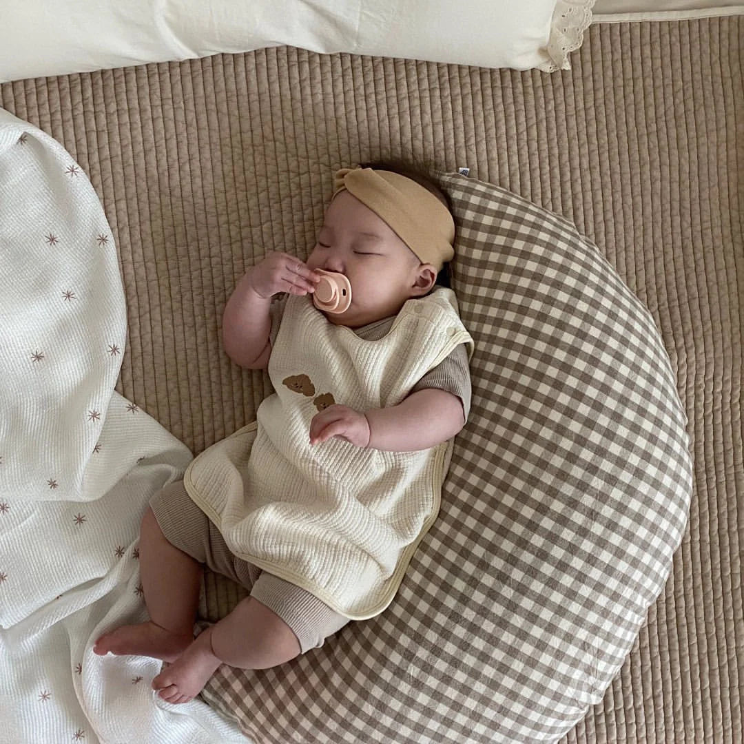 Moon-shaped baby nursing pillow in plaid cotton for newborns, available in yellow, green, and brown