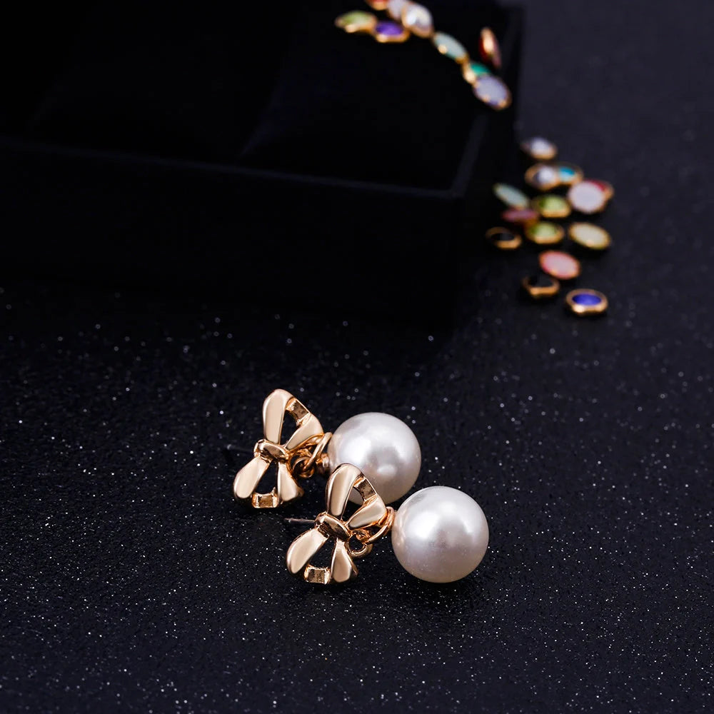 Hypoallergenic heart-shaped zircon and bow pearl earrings for women, ideal for sensitive ears.
