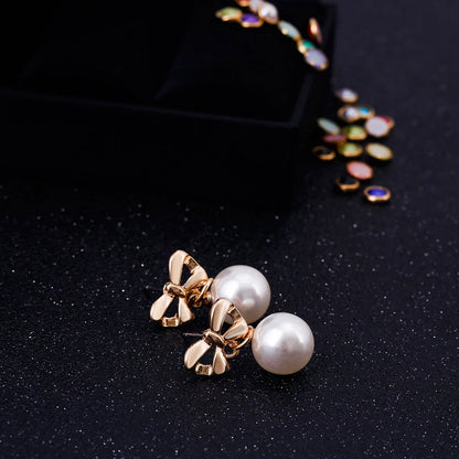 Hypoallergenic heart-shaped zircon and bow pearl earrings for women, ideal for sensitive ears.
