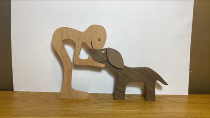 Handcrafted wooden dog sculpture featuring a man and his loyal canine companion