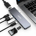 Silver aluminium USB-C hub adapter with SD card slot, HDMI, USB ports, and Thunderbolt 3