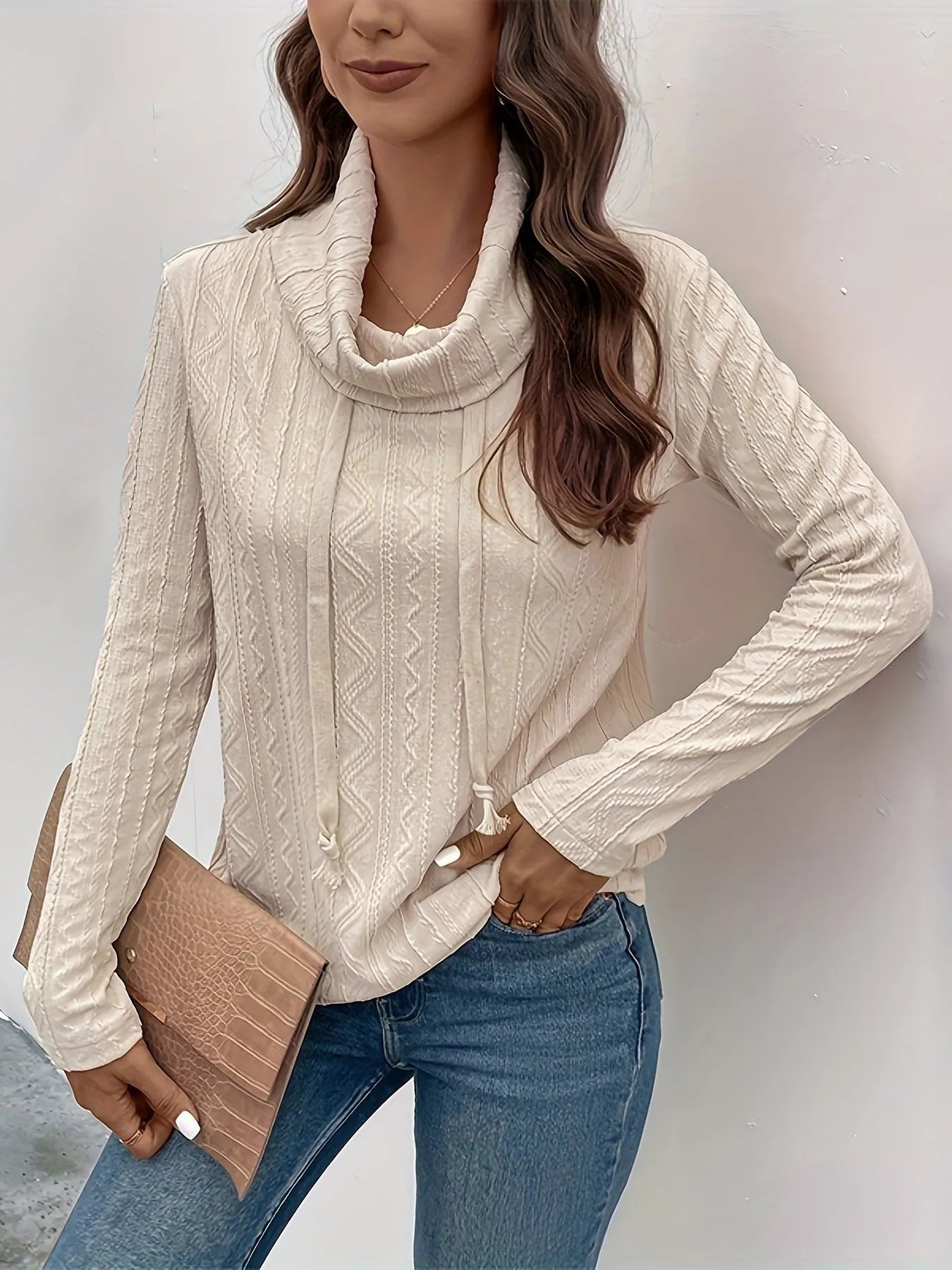 Apricot hooded pullover sweater with drawstring and long sleeves on hanger