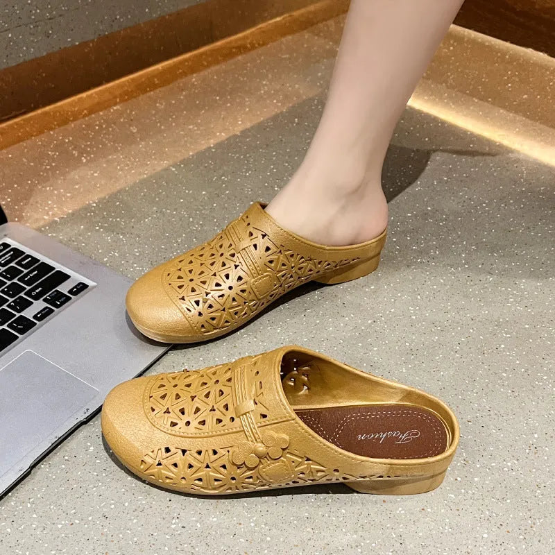 Apricot fairy style flat toe slippers with hollow-out pattern on a white background.