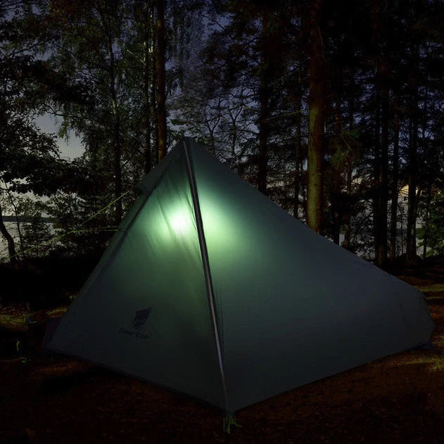 Green poleless camping tent with right opening showing interior 220cm length and 115cm height