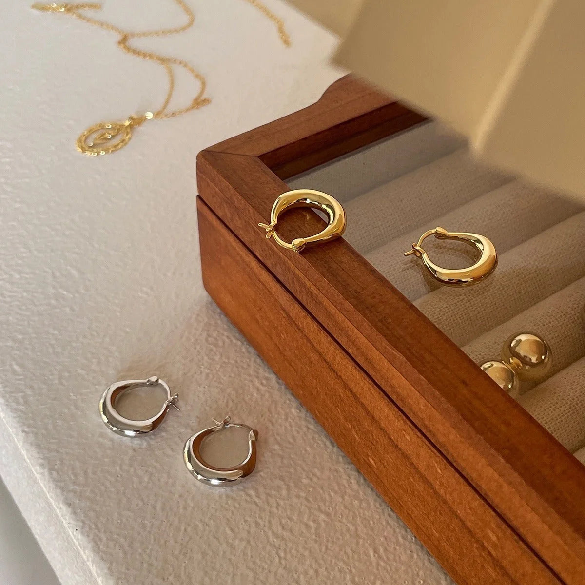 Small fat circle ear clips in white gold and yellow gold finishes for women