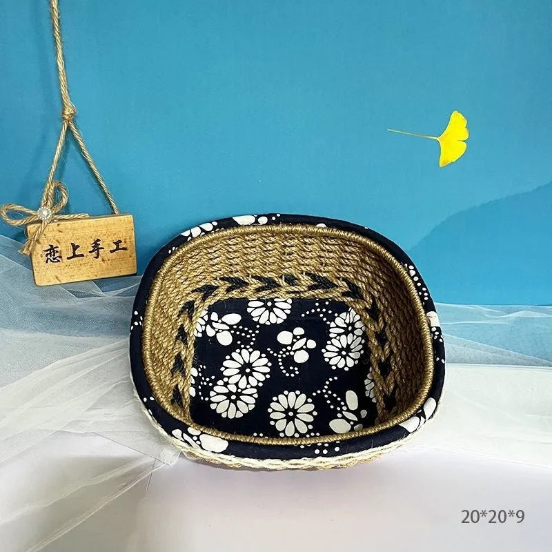 Blue square plastic storage basket with woven texture on a wooden tabletop.