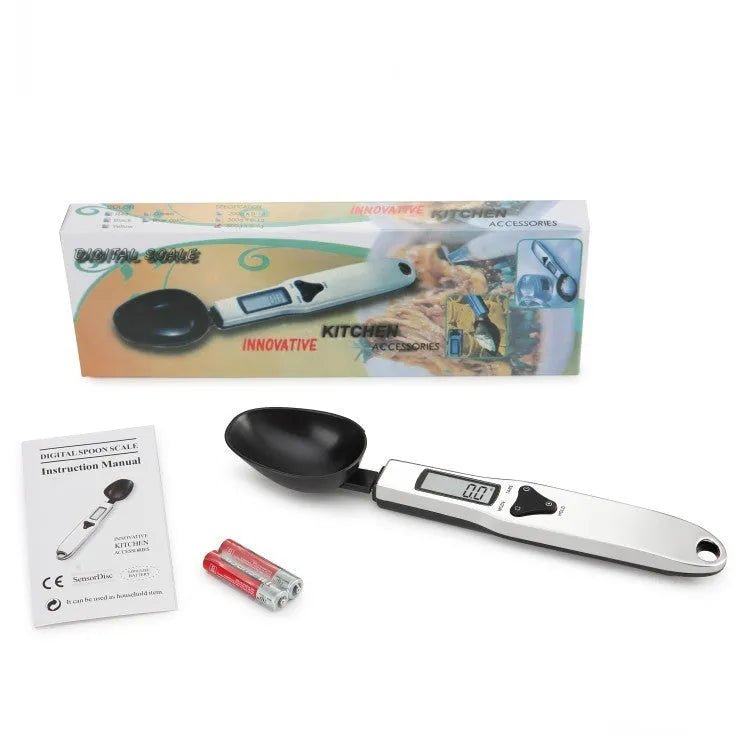 Smart digital kitchen measuring spoon with backlit LCD display showing weight and volume measurements.