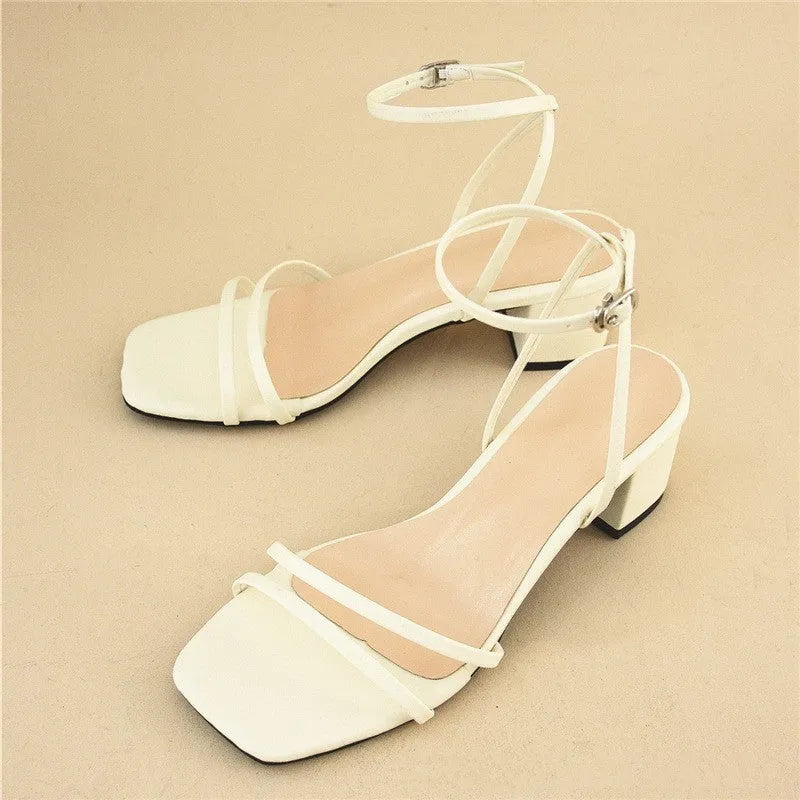 Beige women's stiletto sandals with a chunky block heel and an adjustable ankle buckle strap.