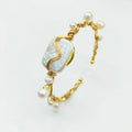 Natural freshwater pearl bracelet with gold titanium steel wire-wrap on hand model