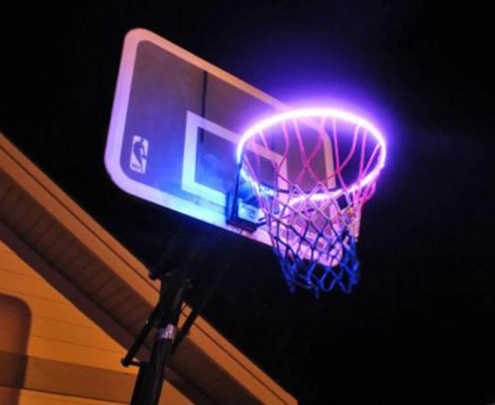 Induction Color Changing Basketball Frame Light attached to a basketball rim, illuminating at night