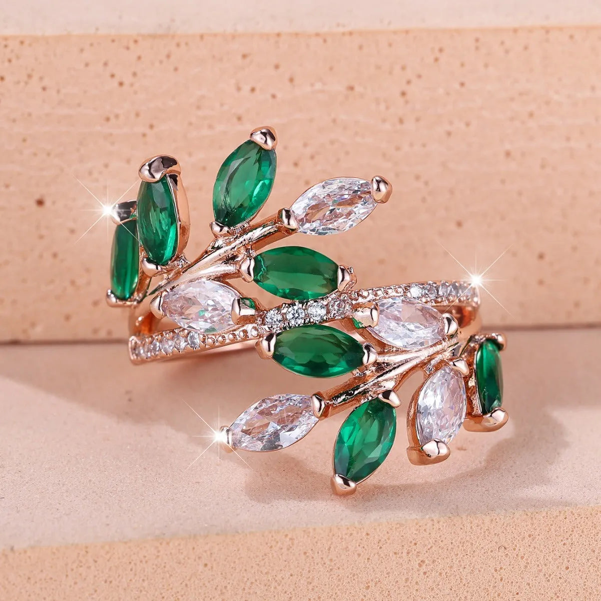 Adjustable copper leaf ring with a zircon stone in a choice of rose gold or platinum finishes.