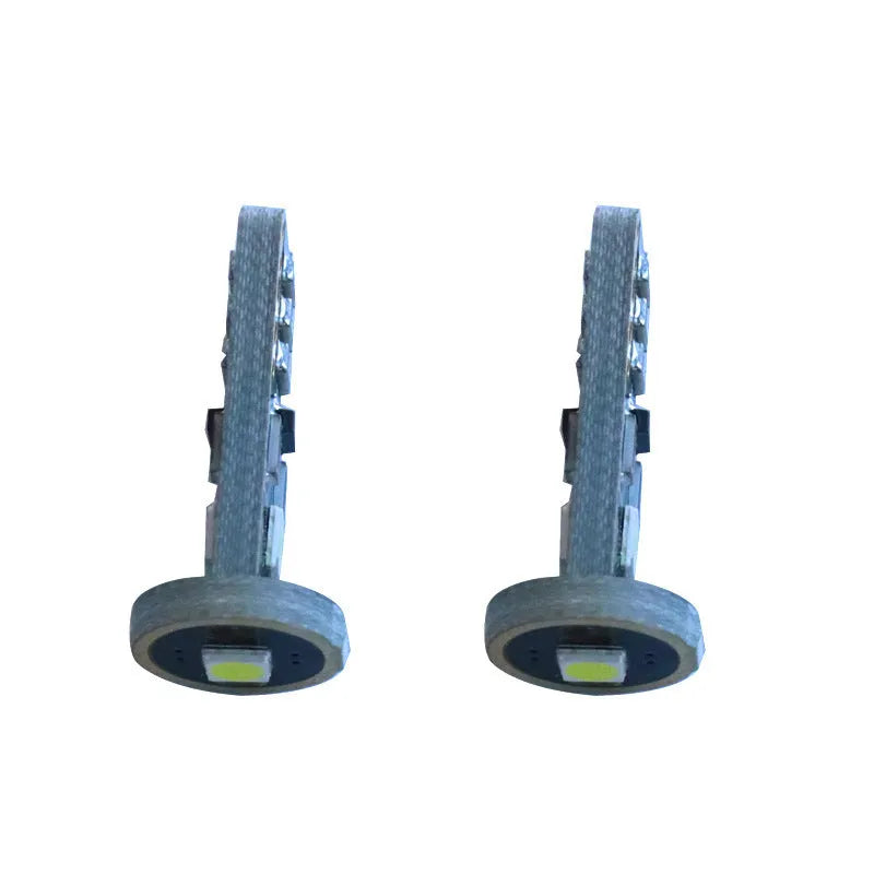 Single T10 W5W LED car interior light bulb with bright white LEDs on a dark board.