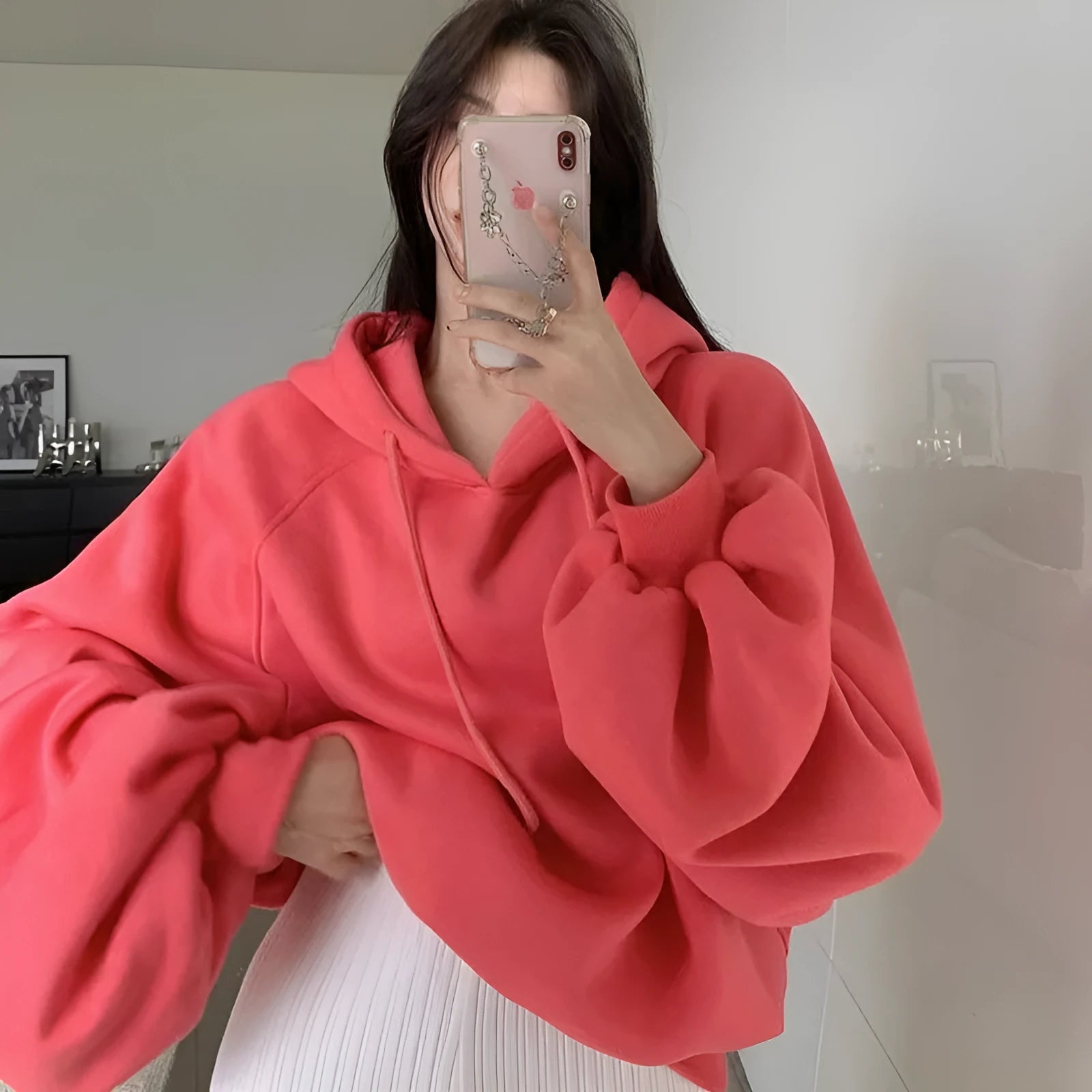 Watermelon red women's loose mulberry silk hooded sweater on a hanger.