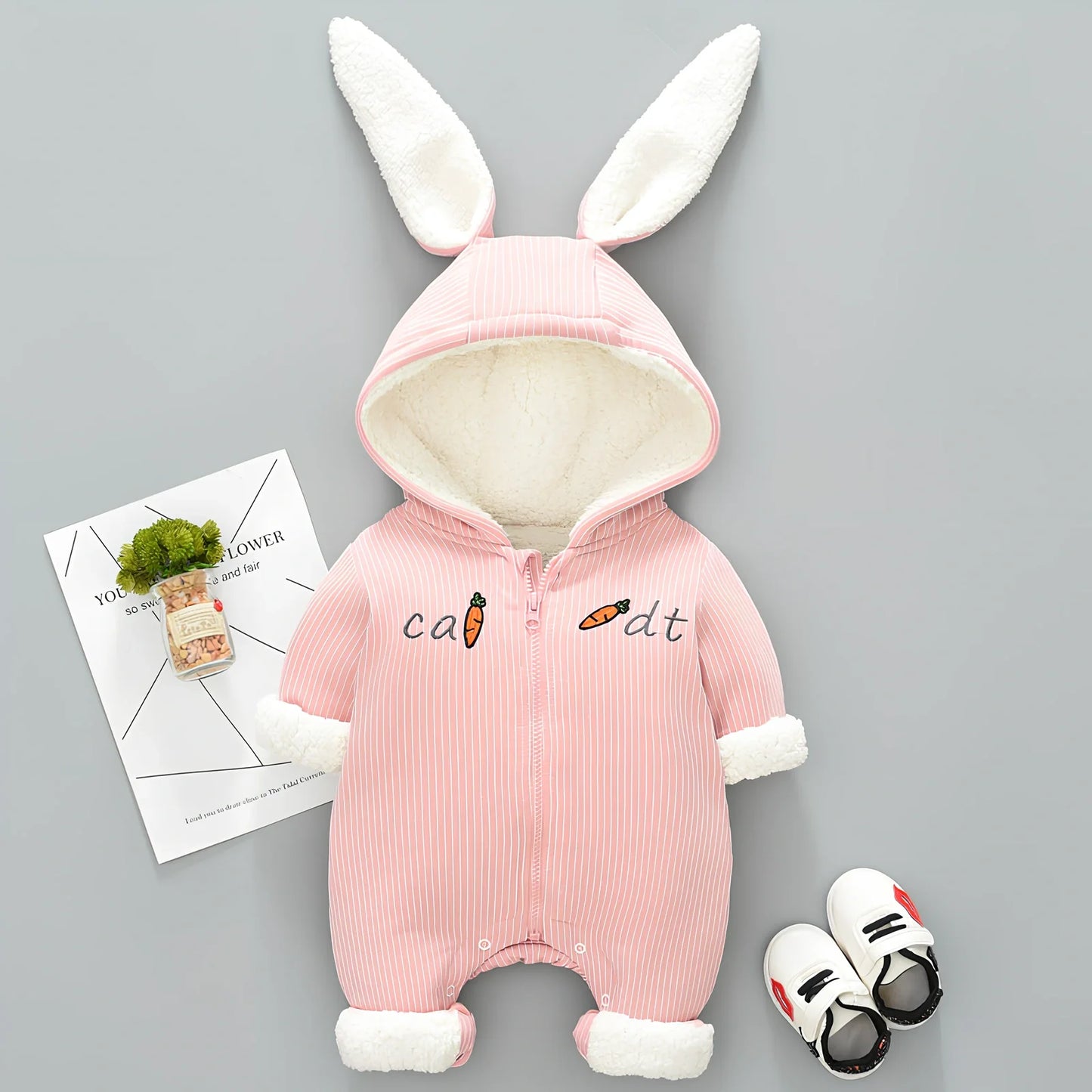 Baby winter jumpsuit with detachable hood in 95% cotton, available in pink and light blue colours