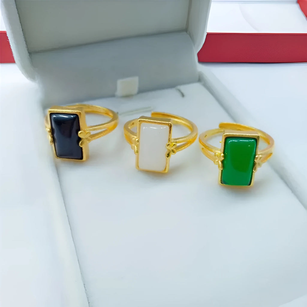 Adjustable brass gold-plated ring with a green gemstone set in a national style design.
