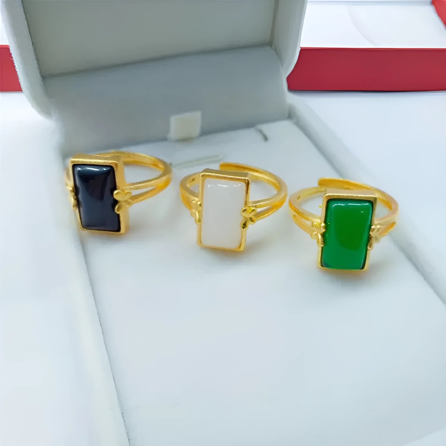 Adjustable brass gold-plated ring with a green gemstone set in a national style design.