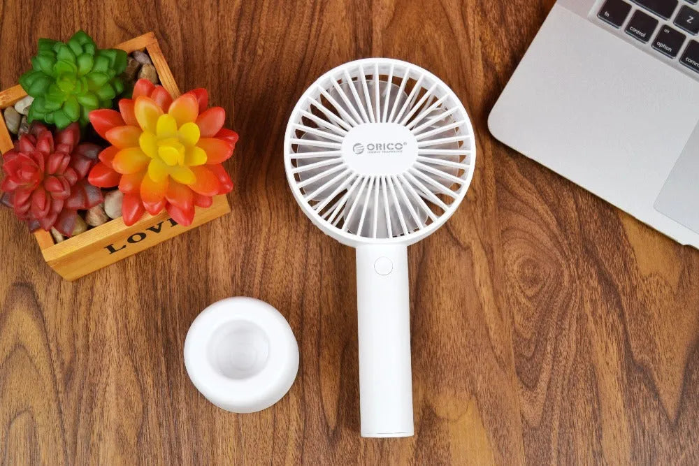 White ORICO FH1 portable USB rechargeable desk fan with three-speed buttons and a fine line pattern on its ABS shell.