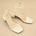 Beige women's stiletto sandals with a chunky block heel and an adjustable ankle buckle strap.