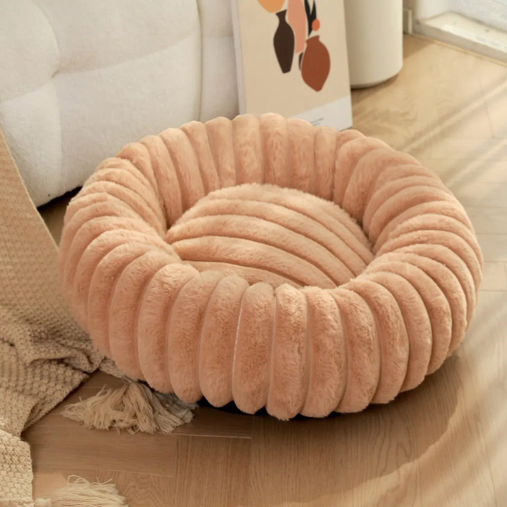 Round long-haired plush pet bed for dogs and cats, shown in beige, with size chart showing S, M, L, XL, XXL, XXXL options.