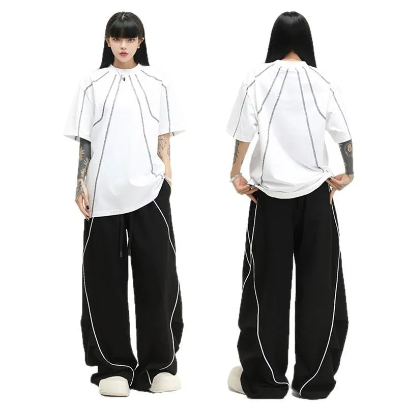 Black striped pleated wide-leg hip hop trousers on hanger showing mid-waist design