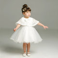 Baby girl fluffy dress two-piece set in beige with soft fabric, displayed on child-sized mannequin