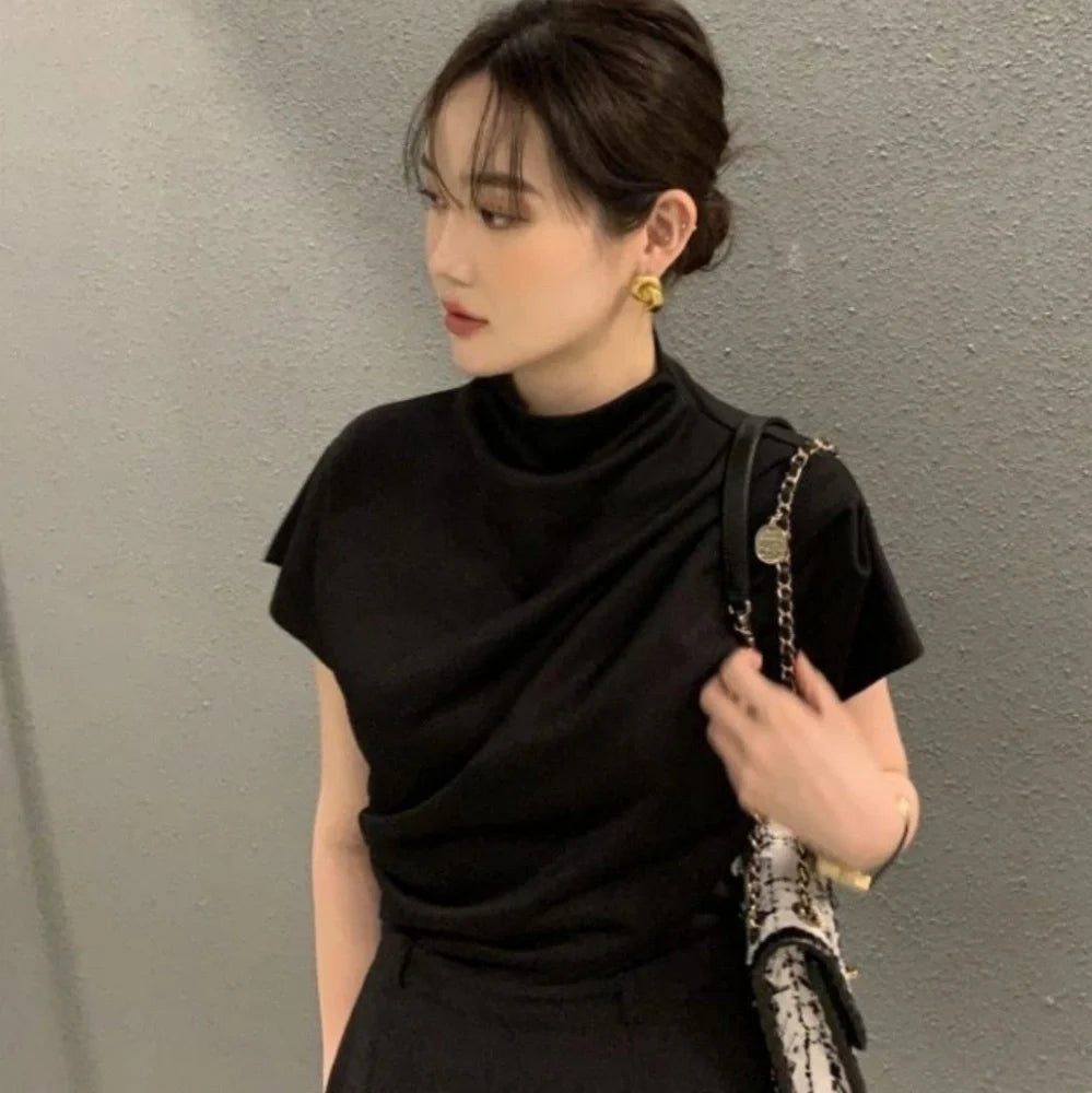 Women's apricot shirt with stand-up collar, diagonal pleats, and flowing short sleeves on hanger