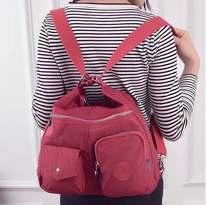 Women's waterproof nylon crossbody bag with organizational pockets and 34cm laptop capacity